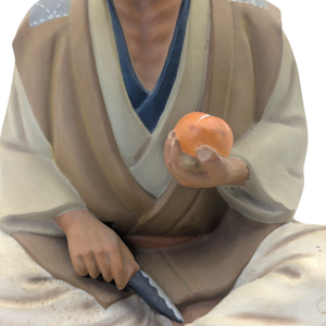 Vintage Man Slicing Orange Japanese Hakata Doll